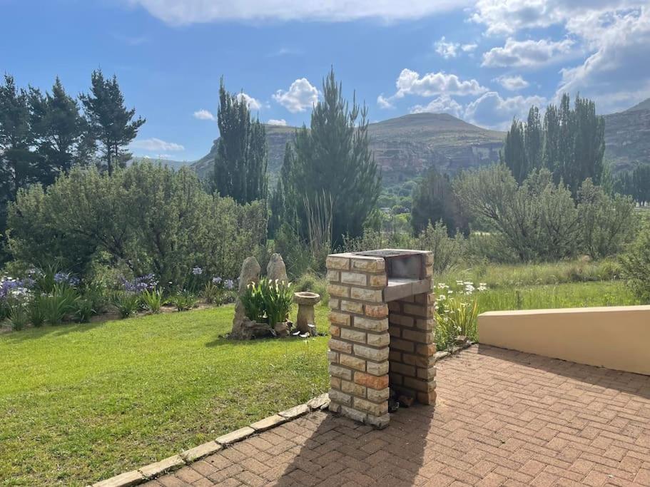 a brick fire hydrant sitting on top of a yard at Stonehenge Clarens in Clarens