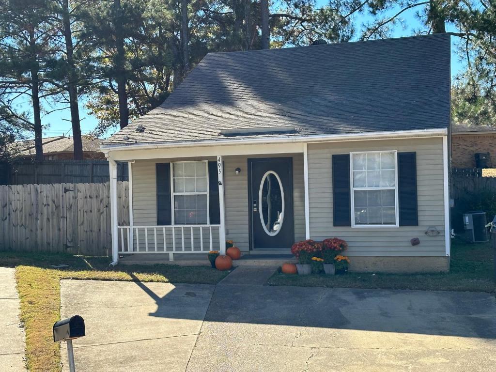 a small house with a blue door and a porch at Perfect Place for Families in Hernando