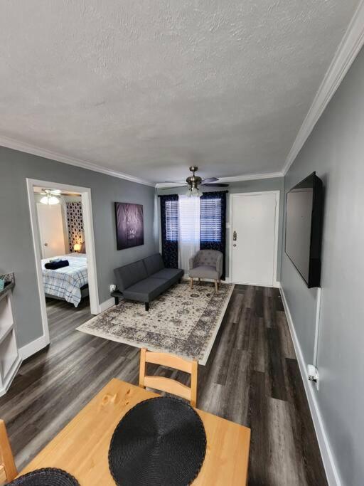 a living room with a couch and a table at Blue Shark *G13* @ Midtown Central 1BR King Apartment in Houston