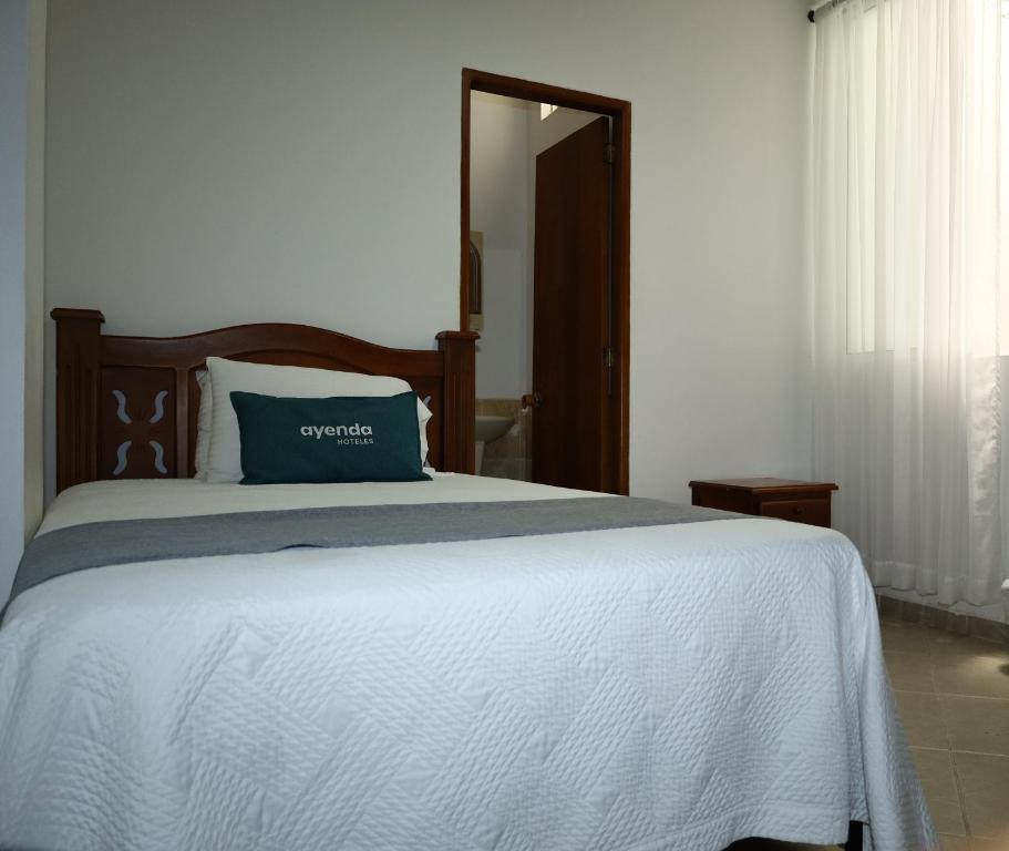 Postel nebo postele na pokoji v ubytování Ayenda Torre 2