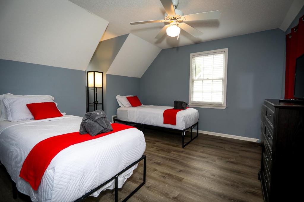 a bedroom with two beds and a ceiling fan at Escape to Serenity Luxurious 4Bedroom 3Bath Oasis with Private Pool Near Fort Jackson in Columbia