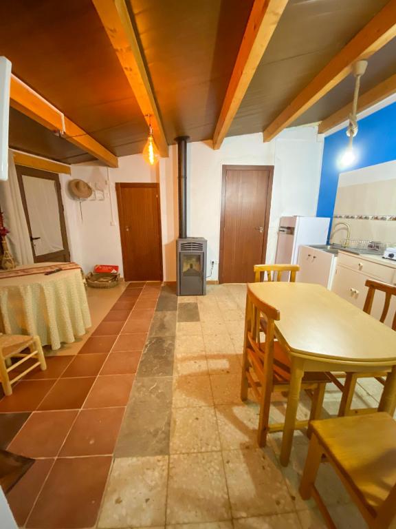 a kitchen with a table and a table and chairs at La Casita Encendida in Villamayor de Campos