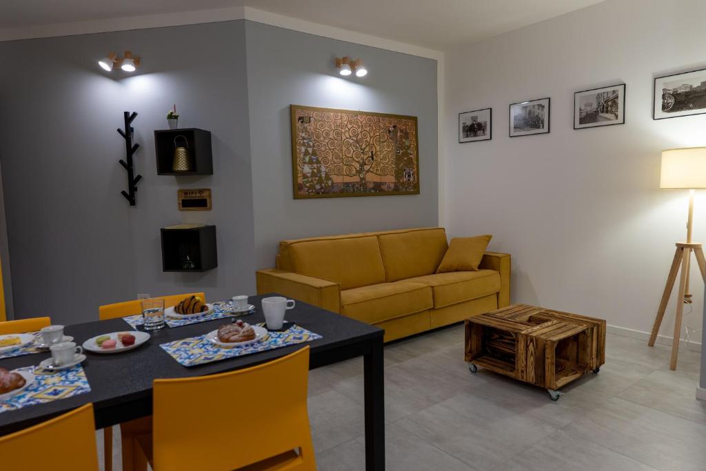 a living room with a table and a couch at La casa sul Naviglio in Milan