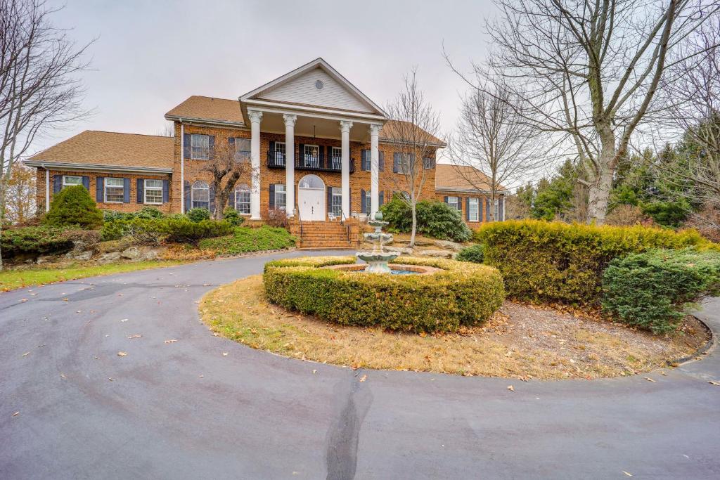 a house with a round driveway in front of it at Immaculate Boone Villa with Entertainment Lounge! in Boone
