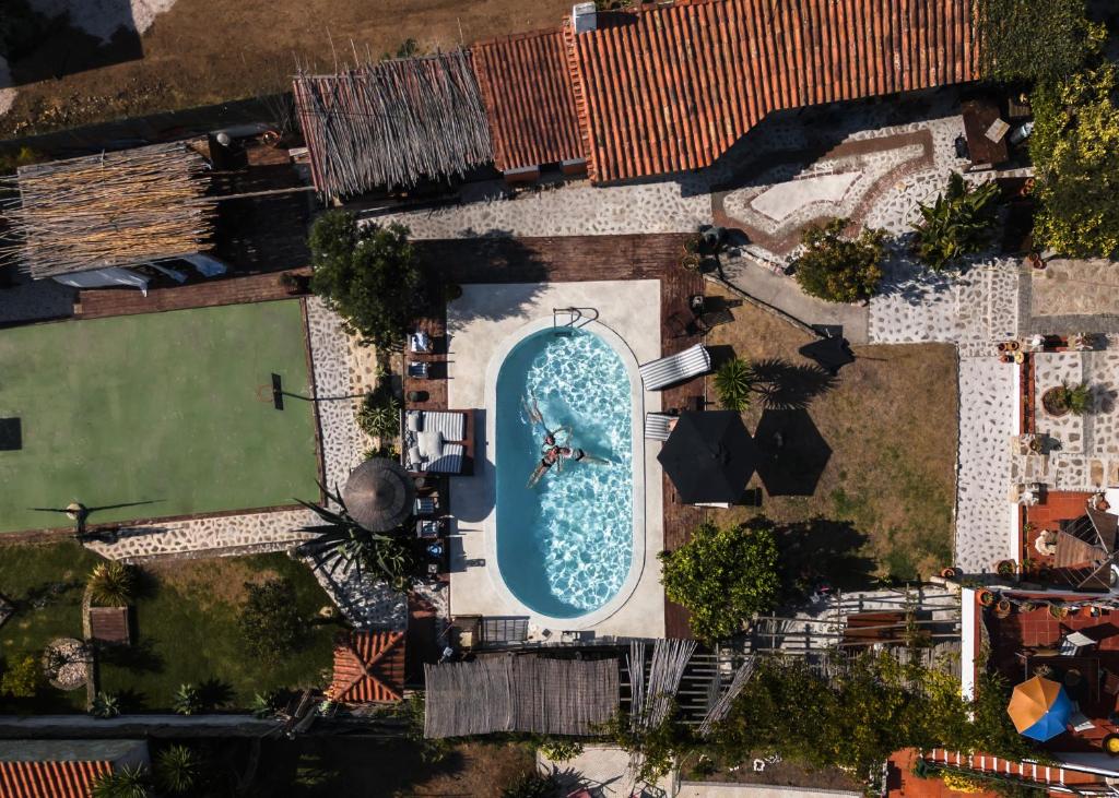an overhead view of a swimming pool with a person in it at João Jungle in Açafora