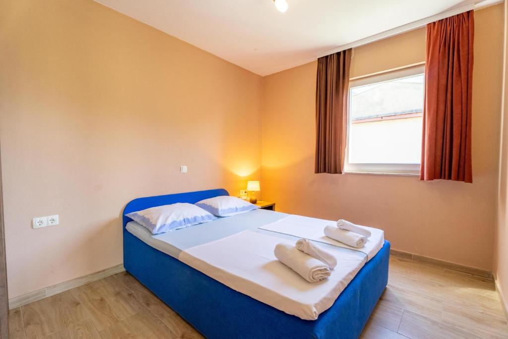 Postel nebo postele na pokoji v ubytování Apartmani Malbašić