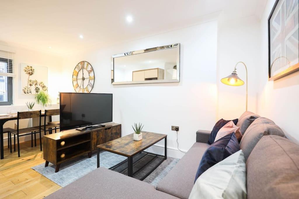 a living room with a couch and a flat screen tv at City Centre, Spacious, Ensuite, Smart TV, Sofa Bed in Bristol