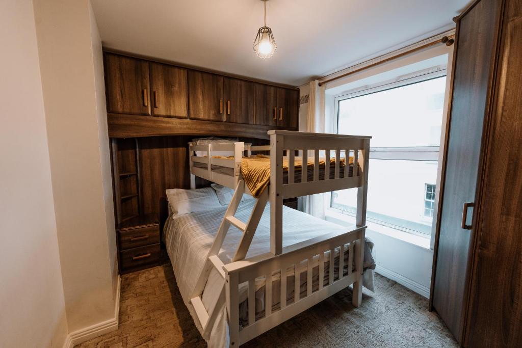 two bunk beds in a room with a window at Smithfield square Nest in Dublin