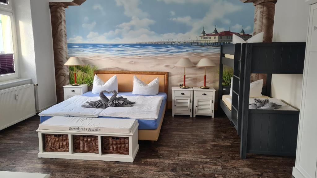 a bedroom with a bed and a painting of the ocean at Pension Domke in Ahlbeck