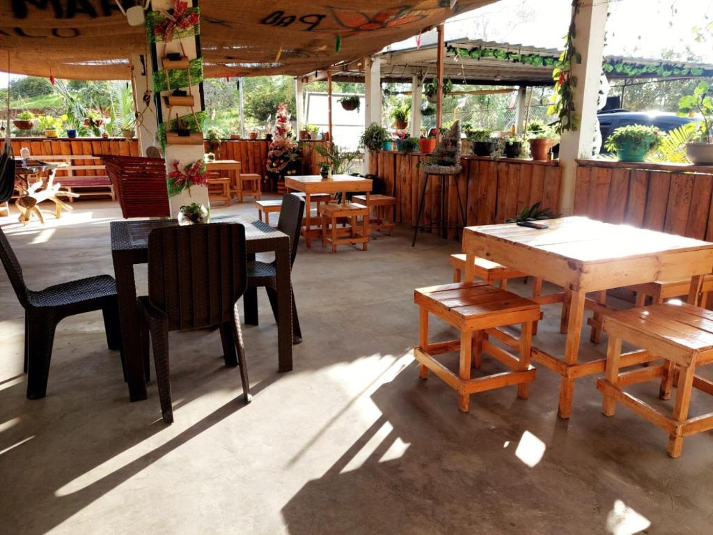 a restaurant with wooden tables and chairs in a room at Hostel paraiso de colores in Popayan