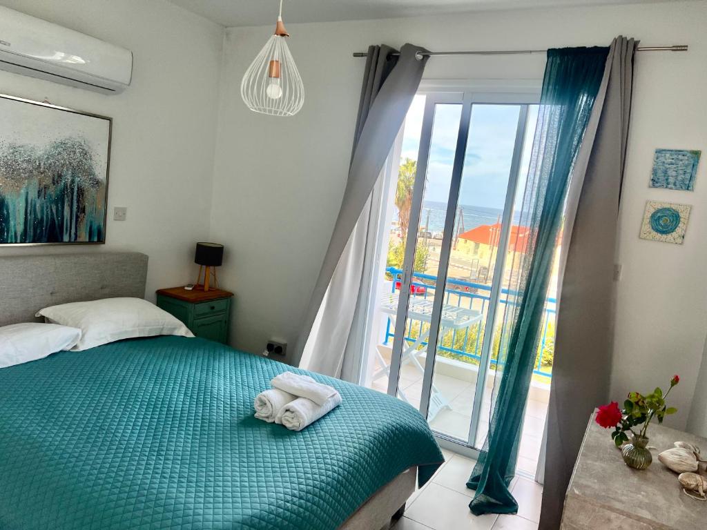 a bedroom with a bed and a large window at LATSI BLUE LAGOON 12 in Lachi