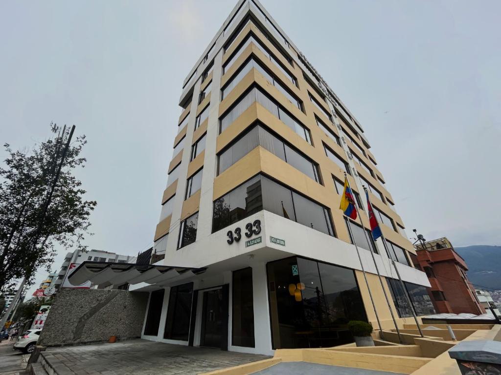 a building with two flags in front of it at Stanford Suites Hotel in Quito