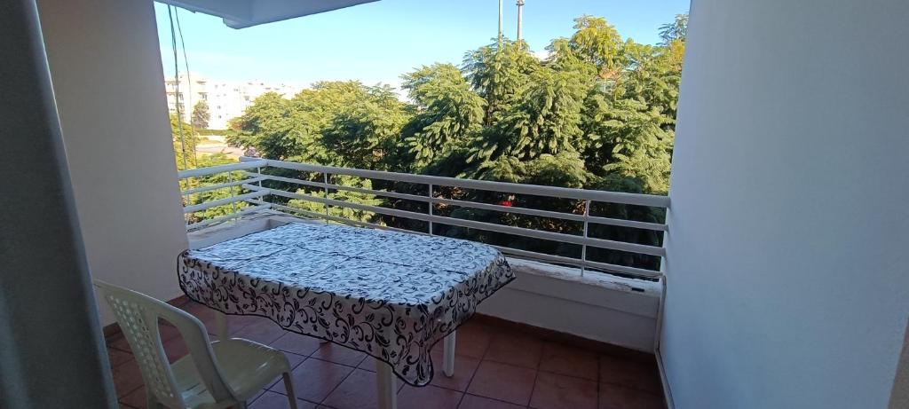 a balcony with a table and chairs and trees at Spacious Apt in Rabat Hay Riad in Rabat