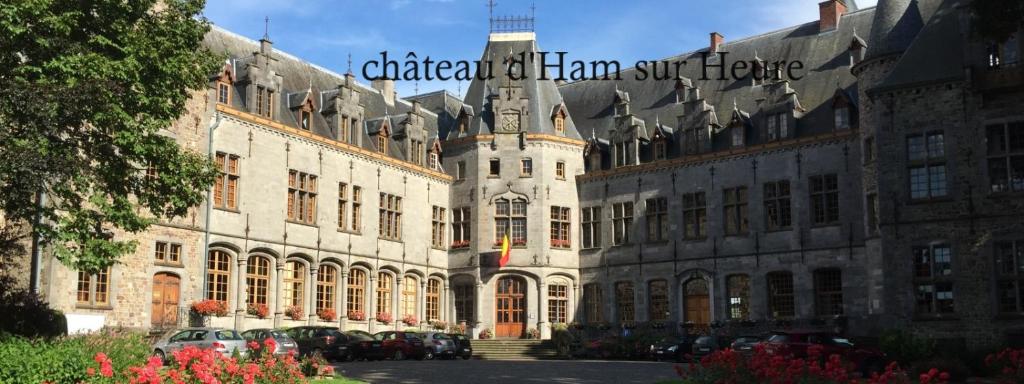 a large building with a sign on the side of it at Le val du vieux chêne chambre d'hôtes in Walcourt