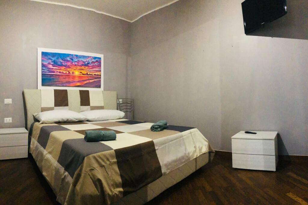 a bedroom with a large bed and a television at Appartamento in zona centrale a uso esclusivo in Bari