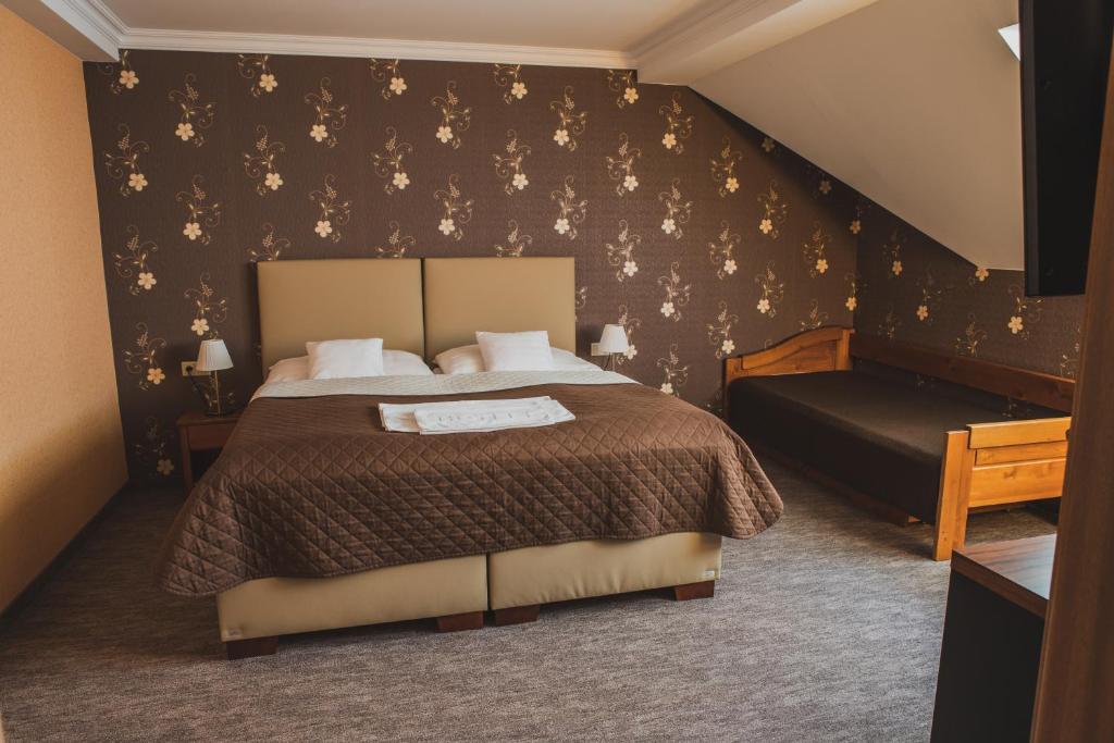 Postel nebo postele na pokoji v ubytování Hotel Lipa