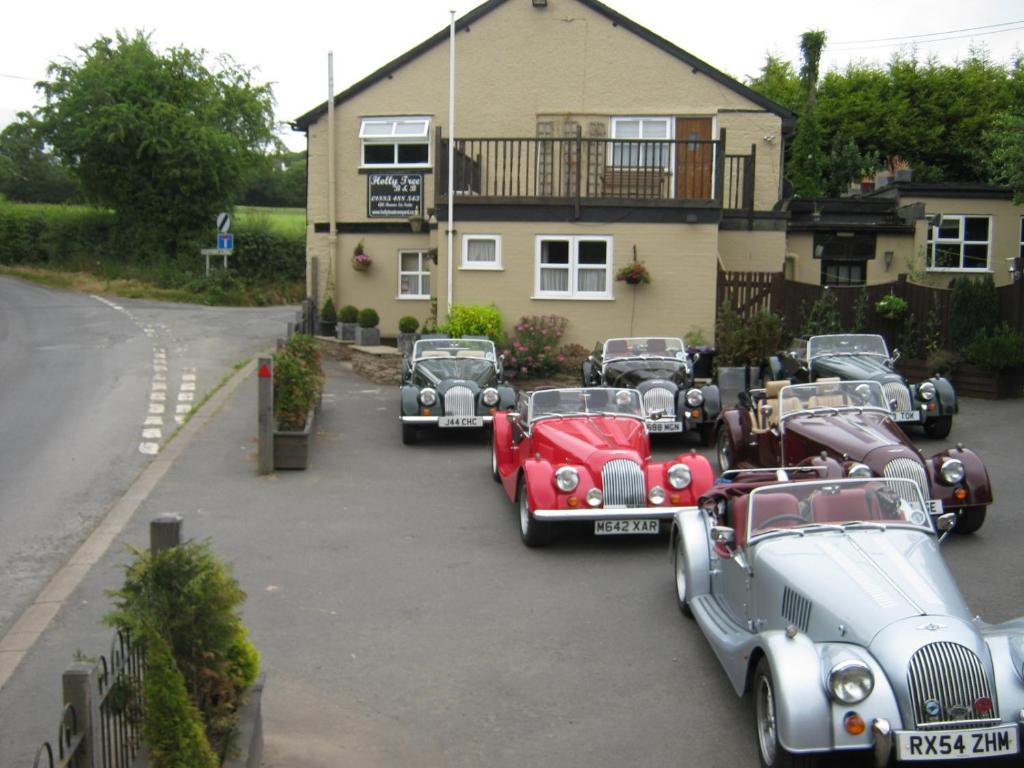 a group of cars parked in front of a house at Holly Tree B&B in Bromyard