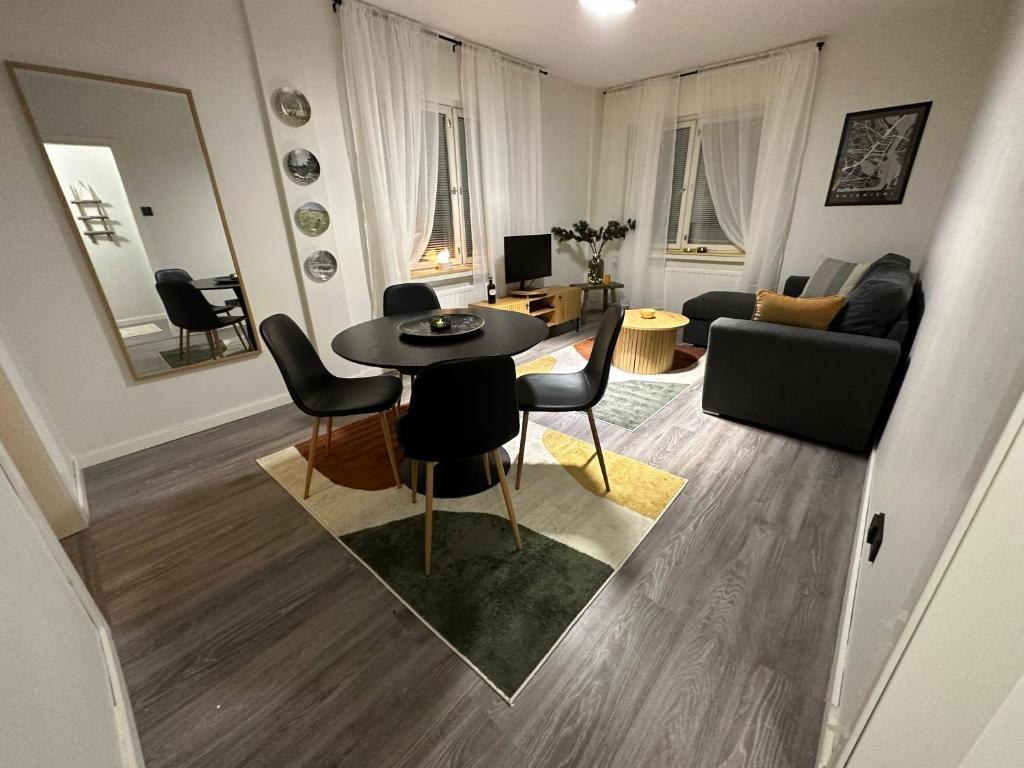 a living room with a table and a couch at Arctic Apartment Rovaniemi in Rovaniemi