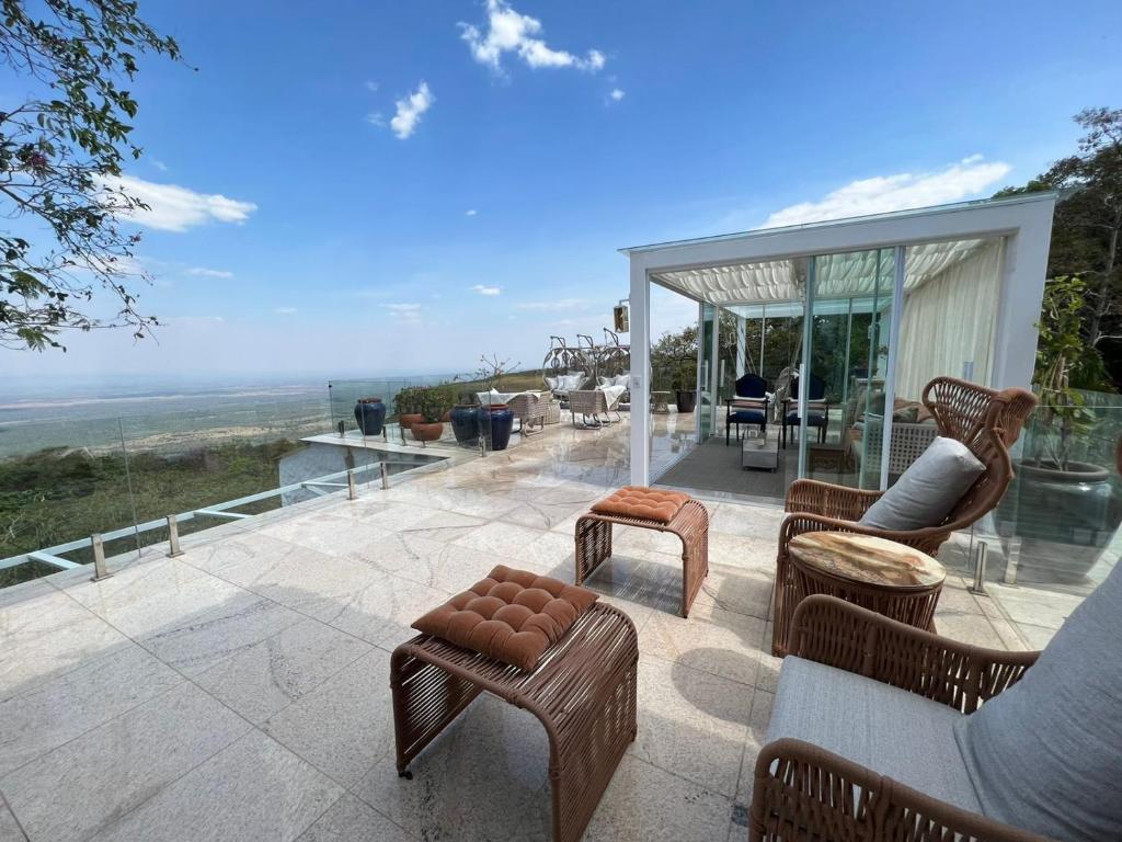 a patio with furniture and a view of the ocean at Atmã Pousada in Chapada dos Guimarães
