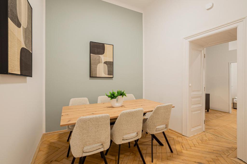 a dining room with a wooden table and chairs at Charming APT perfect for 4-6 tram, self-checkin in Vienna
