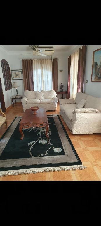 a living room with a couch and a coffee table at Soliman Villa in Luxor