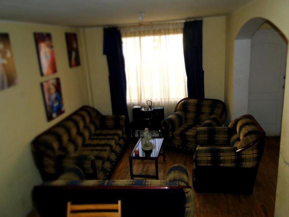 a living room with two couches and a coffee table at GUESTHOUSE MOUNTAIN TRAVEL ECUADOR 