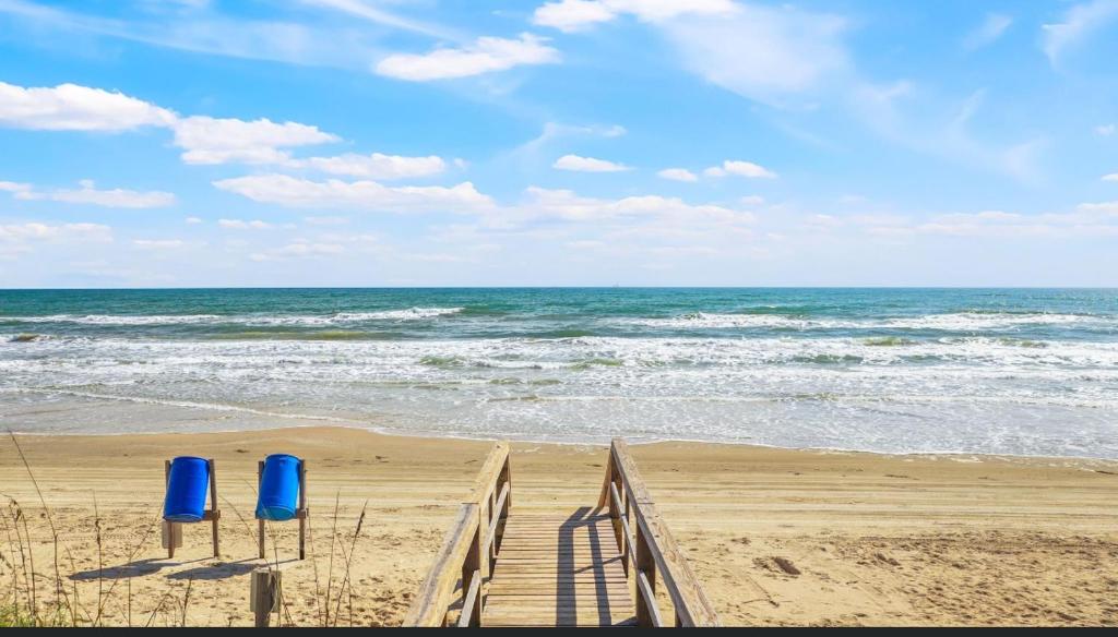 two blue barrels on a sandy beach near the ocean at Beachfront Retreat! 3 Steps to WALKOVER! in Surfside Beach