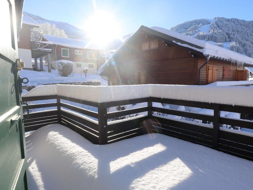 a fence covered in snow in front of a house at Chalet familial 12 pers, Arêches-Beaufort, proche commerces - FR-1-342-292 in Beaufort