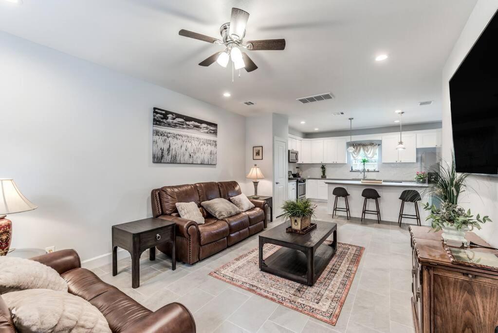 a living room with a couch and a ceiling fan at Stylish 3 BDR House 5 miles to Downtown! in Houston