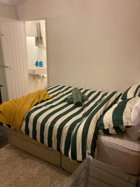 Una cama con un animal de peluche encima. en Wendover St, High Wycombe, en Buckinghamshire
