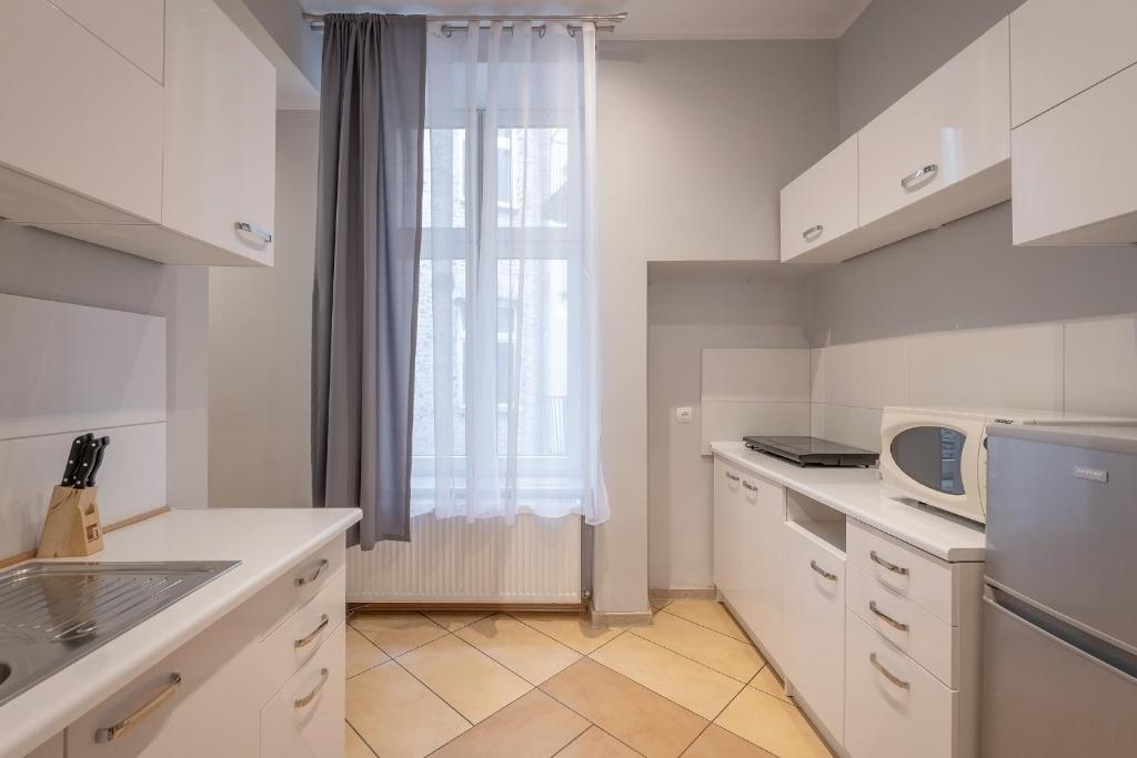 Kuchyňa alebo kuchynka v ubytovaní Queen Apartments
