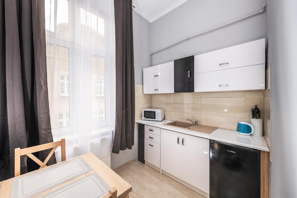 Kuchyňa alebo kuchynka v ubytovaní Queen Apartments