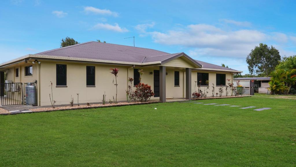 a house with a lawn in front of it at Hans Christian - A family acreage escape in Sarina