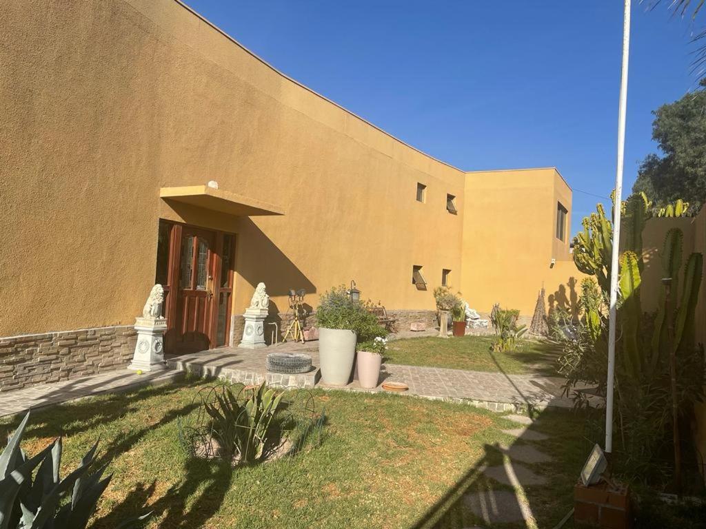 a building with a giraffe standing outside of it at Hotel Boutique Azhares in Copiapó