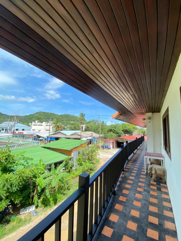 a view from the balcony of a house with a wooden ceiling at TNP place in Thong Nai Pan Yai
