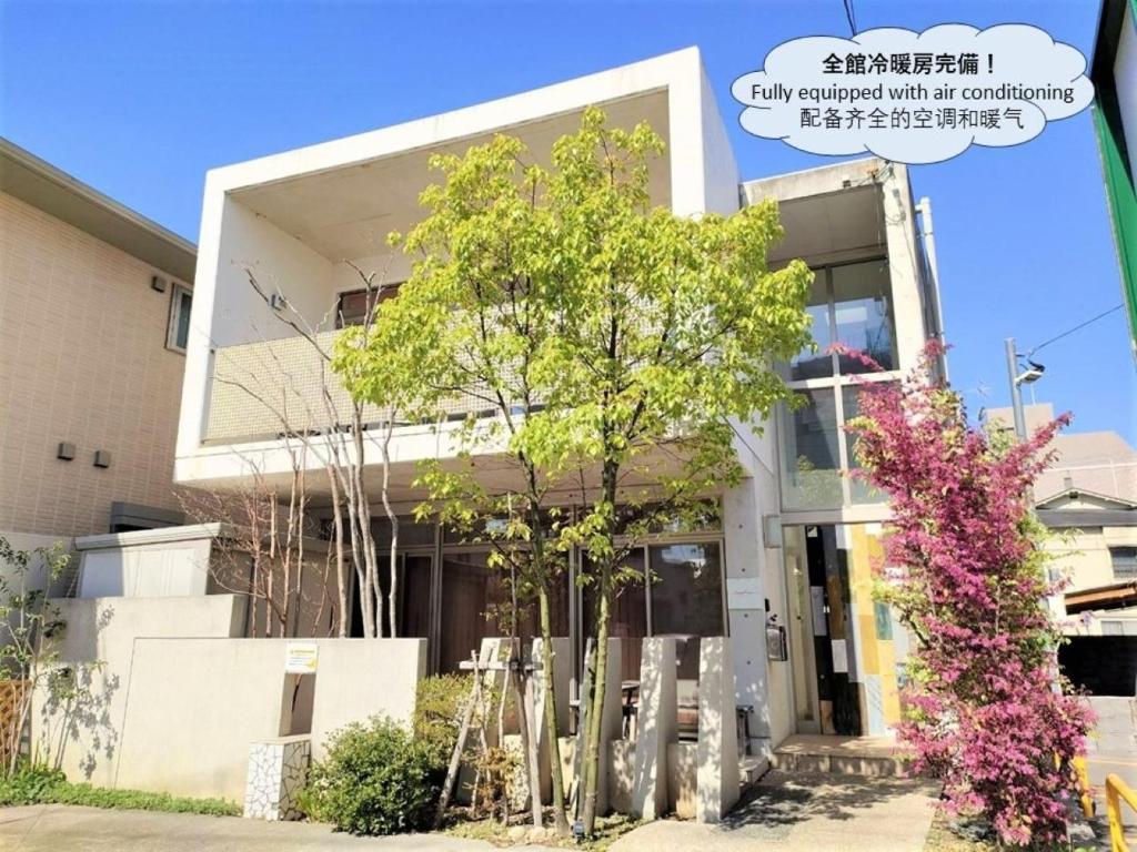 um edifício com uma árvore em frente em Kumamoto - House - Vacation STAY 83489 em Kumamoto