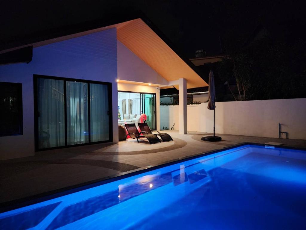 a swimming pool in a house at night at PoolVilla 234 Patong in Patong Beach