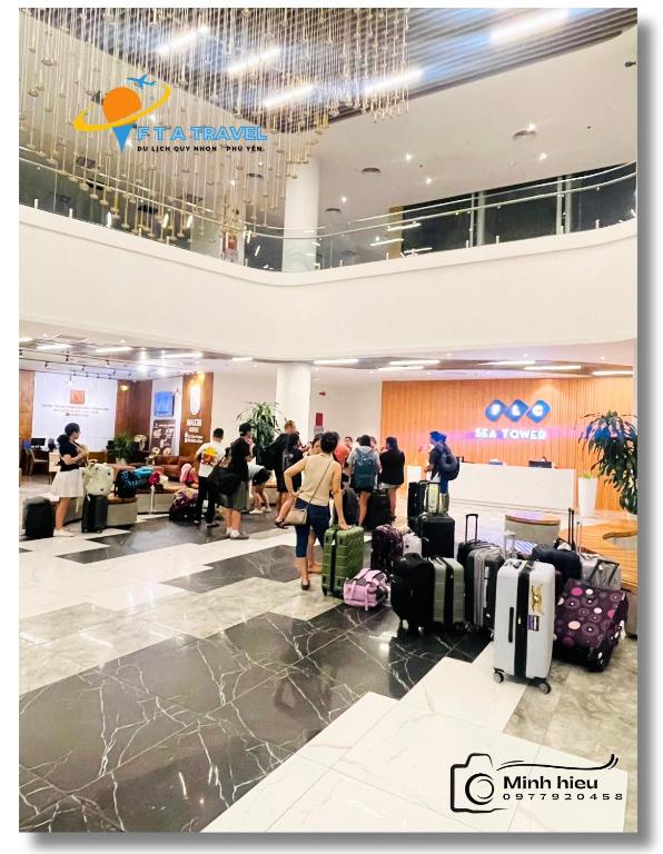 a group of people waiting for their luggage at an airport at FLC Luxury Apartment Quy Nhon in Quy Nhon