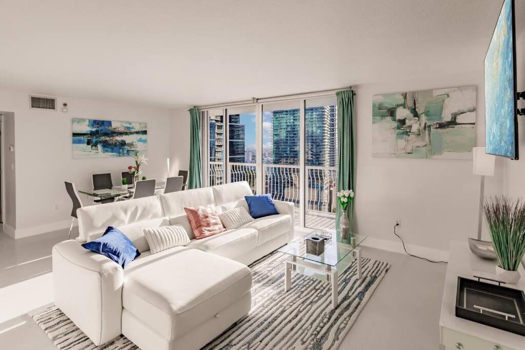 a white living room with a white couch and a table at Upscale Brickell 2 bedroom with water views and free parking in Miami