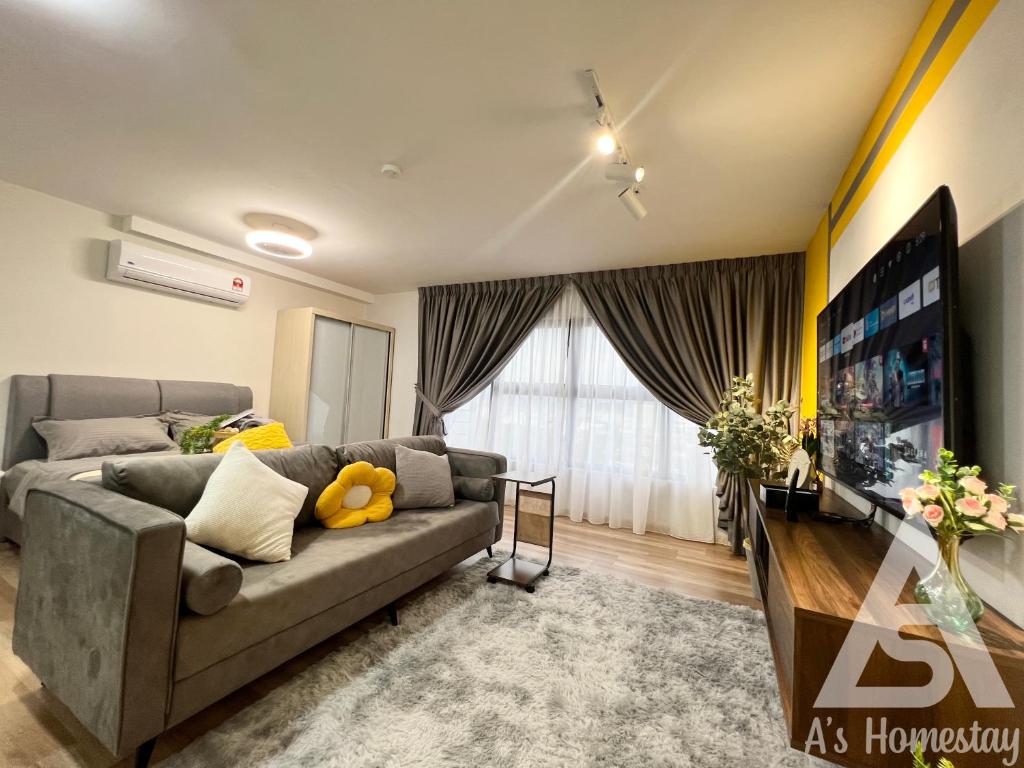a living room with a couch and a flat screen tv at Arte Cheras Romantic MRT Cheras Wi-Fi Smart Tv AsHome in Kuala Lumpur