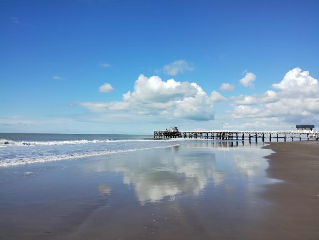 a beach with a pier and the ocean at Casa Mar in La Lucila del Mar