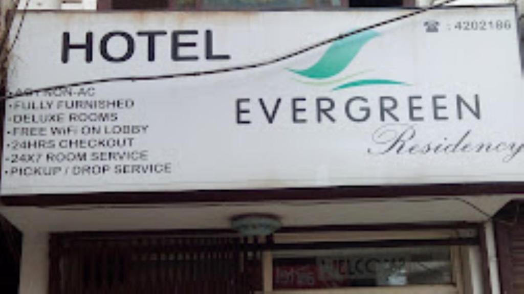 a sign for a hotel in front of a building at Hotel Evergreen Residency , Bhopal in Bhopal