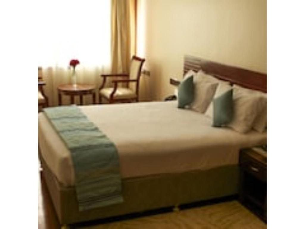 a bedroom with a large bed in a room at O'sinkirri in Nairobi