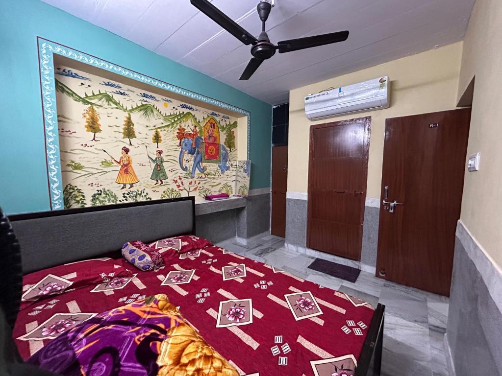 a bedroom with a bed and a large painting on the wall at MOON NIGHT GUEST HOUSE in Jodhpur
