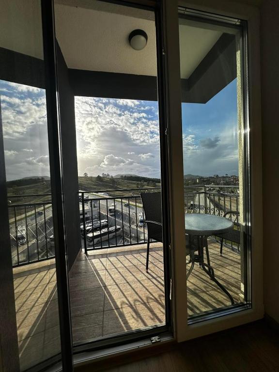 a view of a balcony with a table and a view at Gondola Neda Lux in Zlatibor