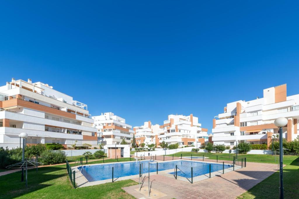 uma vista para edifícios de apartamentos com uma piscina em Agua Serena em Roquetas de Mar