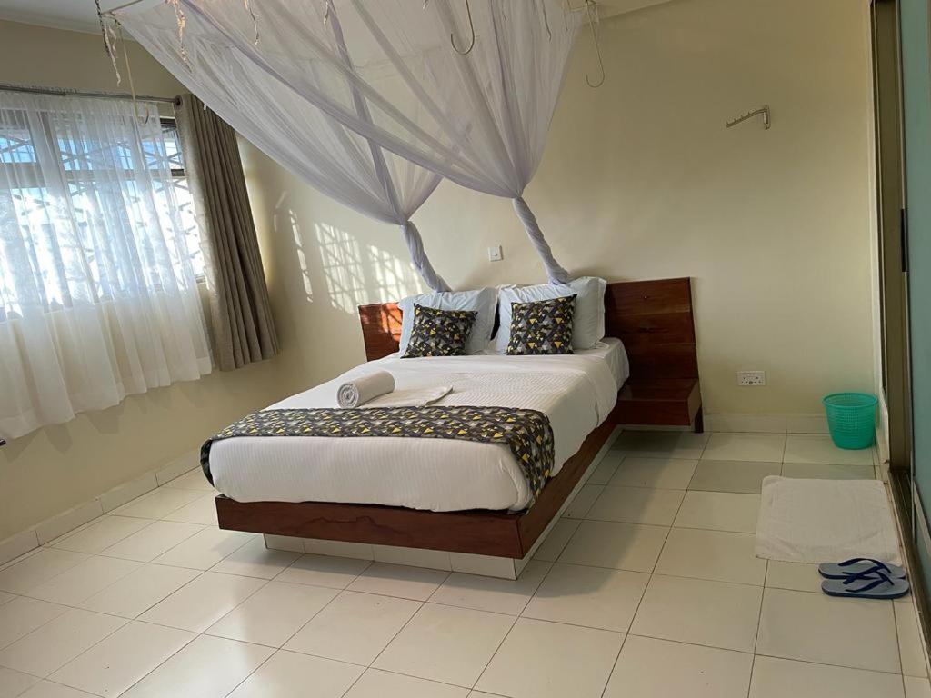 a bedroom with a large bed in a room at Hotel Cavallino in Kakamega