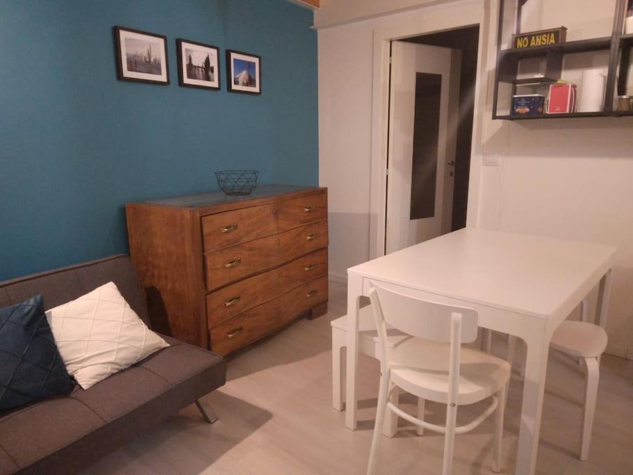 a living room with a white table and a couch at SeaHarbour Pesaro in Pesaro