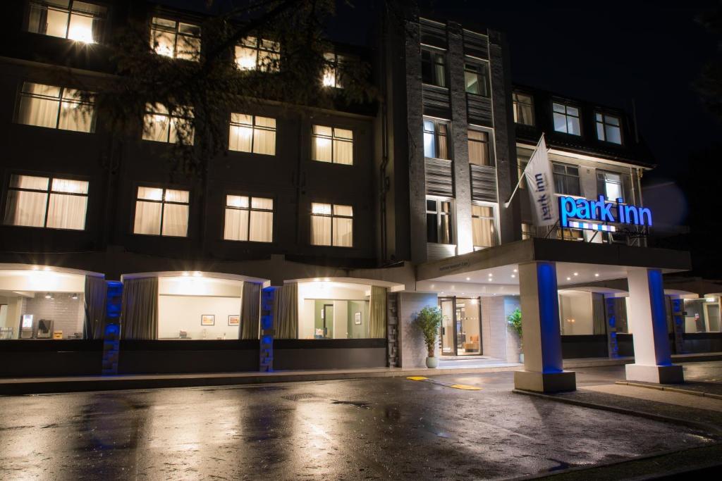 a building with a sign that reads penalty inn at night at Park Inn by Radisson Bournemouth in Bournemouth