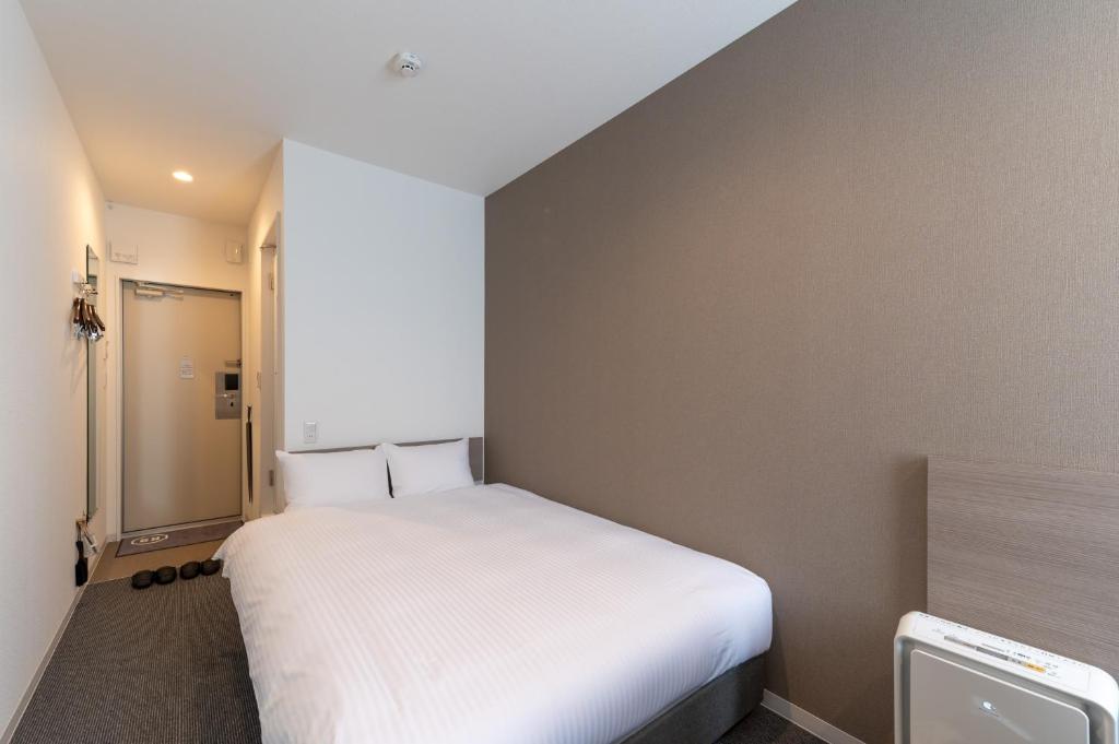 Postel nebo postele na pokoji v ubytování HOTEL R9 The Yard Isesaki